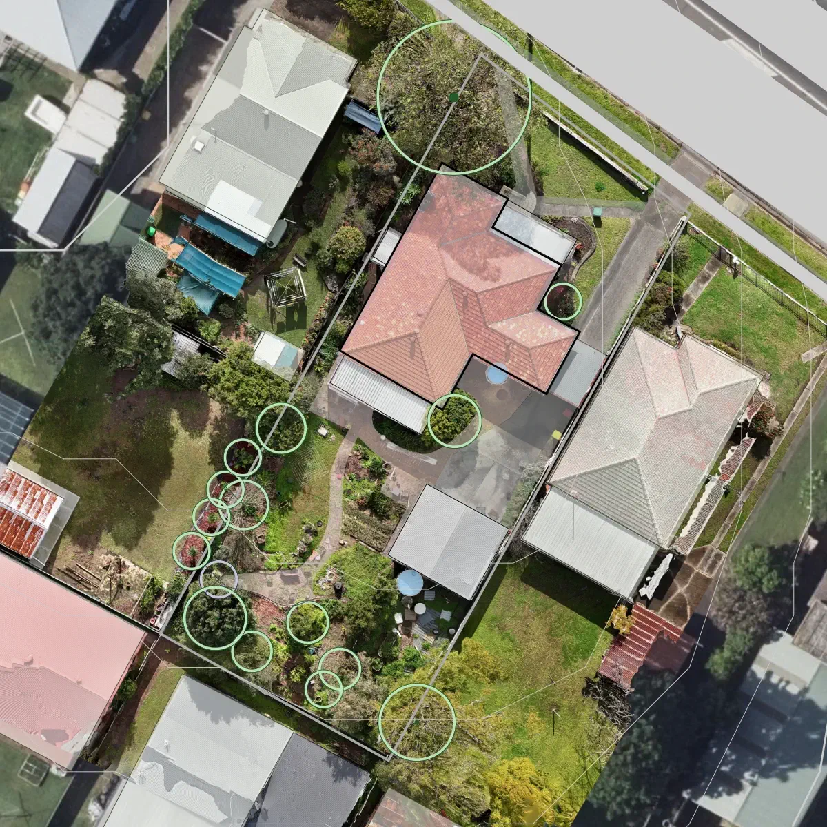 With aerial or drone imagery in place, we can trace existing features such as structures, paved areas, mark out existing water tanks and trees.